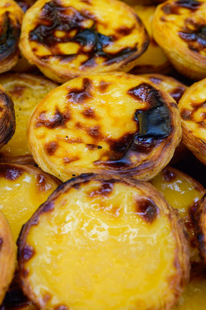 Portugal's traditional sweet dessert Pastel de nata egg custard tart pastry served with view on...