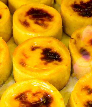 Baked sweet desserts cakes on display in balery in Lisbon, Portugal, close up
