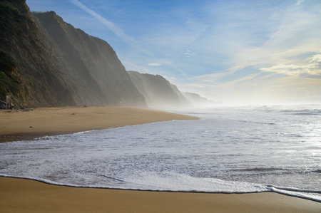 Magoito Beach on Atlantic ocean at sunset, beautiful sandy beach on Sintra coast, Lisbon district,...