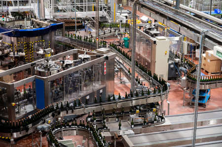 Production of cremant sparkling wine in Burgundy, France. Automatically powered bottling and corking lines on factory.のeditorial素材