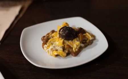 Homemade scrambled eggs with forest mushrooms , close upの写真素材