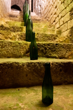 Collection of different sizes of champagne bottles is caves, making champagne sparkling wine from chardonnay and pinor noir grapes in Epernay, Champagne, North Franceの写真素材