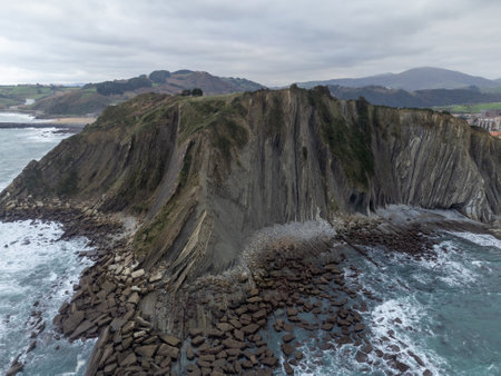 View on steeply-tilted layers of flysch geological formation on Atlantic coast at Zumaia at low...