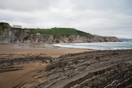 View on steeply-tilted layers of flysch geological formation on Atlantic coast at Zumaia at low...