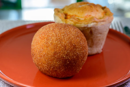 Traditional street food in UK, stuffed fried Scotch eggs with breadcrumbs and baked pie with pork...