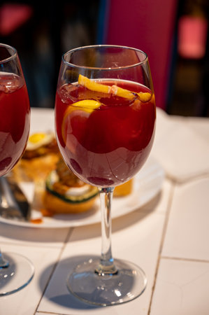 Glass of cold sangria wine served with orange in old bar in San Sebastian, Basque Country, Spainの写真素材