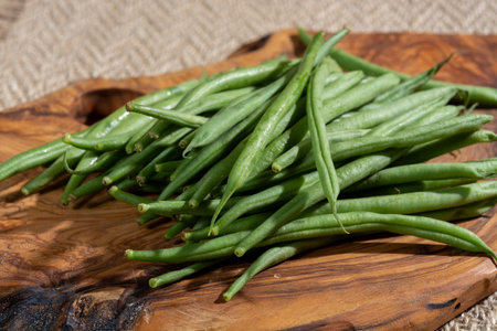 Raw fresh organic green beans ready to cook close up