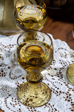 Antique German glassware, old Dutch style rummer or rummer glasses for white riesling wine on old handmade white lace tableclothの写真素材