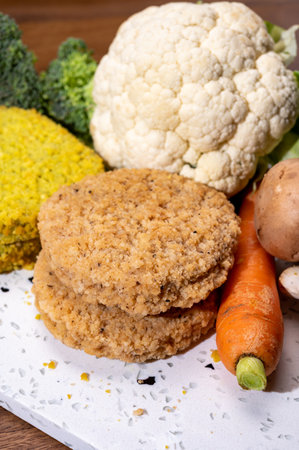 Uncooked fresh vegan and vegetarian burgers made from fresh vegetables and dried legumes and beans, ready to barbecue grillの写真素材