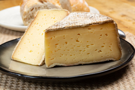 Pieces of cheese tomme de montagne or tomme de savoie made from cow milk in French Alps, France, close upの写真素材
