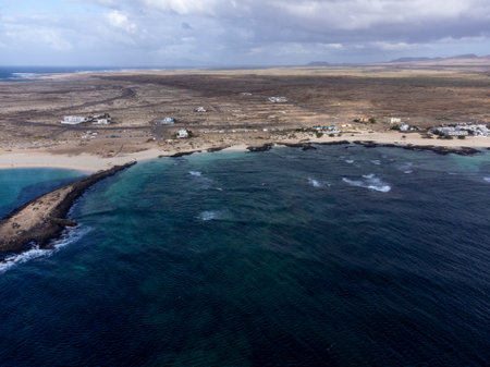 Aerial view on white sandy dunes, blue ocean water on La Concha beach, El Cotillo surfers village, Fuerteventura, Canary islands, winter in Spainの写真素材