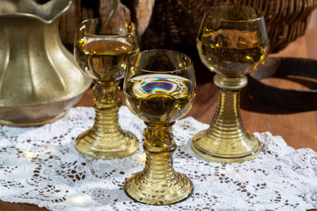 Antique German glassware, old Dutch style rummer or rummer glasses for white riesling wine on old handmade white lace tableclothの写真素材