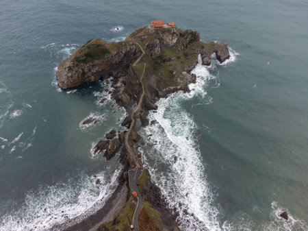 Atlantic ocean coastline near famous landmark and film location in North of Spain, ocean islet with chapel San juan de Gaztelugatxe, Basque Country, Spain in wintertimeの写真素材