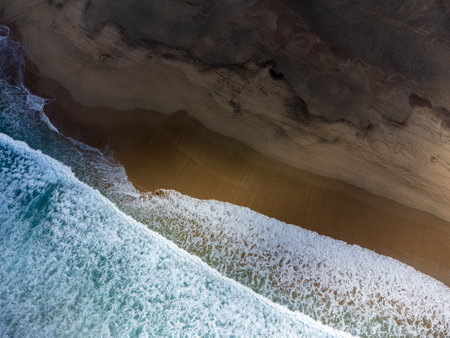 Aerial view on difficult to access golden sandy long Cofete beach hidden behind mountain range on Fuerteventura, Canary islands, Spainの写真素材