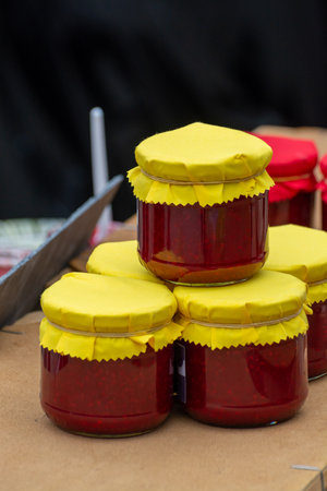 Organic homemade strawberry jam in glass jar for sale in fruit region on Netherlands, West Betuwe,...