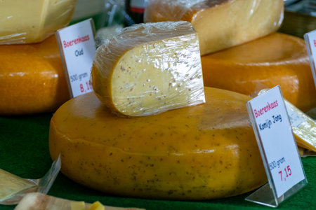 Tasting of different cheeses in Dutch cheese farm shop, English translation is Farmers cheese kumin...