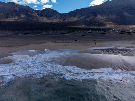 Aerial view on difficult to access golden sandy long Cofete beach hidden behind mountain range on Fuerteventura, Canary islands, Spainの写真素材