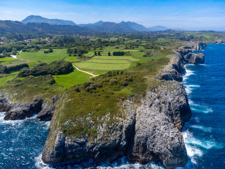 Aerial view on colorful coastline of Green coast of Asturias, North Spain with sandy beaches, cliffs, hidden caves, green fields and mountains.の写真素材
