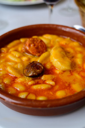 Fabada asturiana, Asturian bean stew, Spain, hot and heavy dish served with Asturian cider or a red wine, made with fabes de la Granja large white beans, shoulder pork, pancetta or bacon, morcilla blood sausage, chorizo close upの写真素材