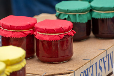 Organic homemade strawberry jam in glass jar for sale in fruit region on Netherlands, West Betuwe, close upの写真素材