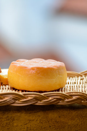 Spanish hard smoked cow cheese from Pria, Asturias, served outdoor with view on San Lorenzo beach and promenade in Gijonの写真素材