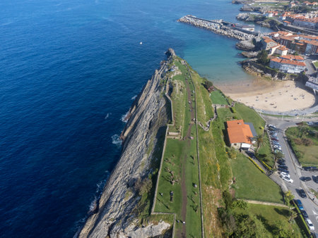 Aerial view on coastline and old harbor of Llanes, Green coast of Asturias, North Spain with white sandy beaches, cliffs, hidden caves, green fields, forests and mountains.の写真素材