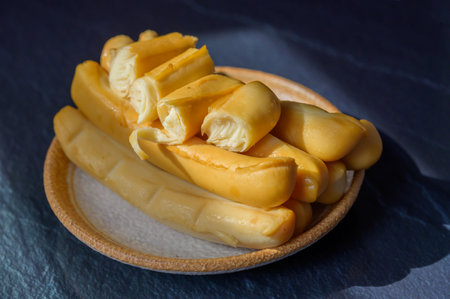 Cheese collection, Italian yellow smoked caciocavallo or scamorza cheese sticks from Puglia, tasty...