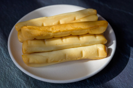 Cheese collection, Italian yellow smoked caciocavallo or scamorza cheese sticks from Puglia, tasty snackの写真素材