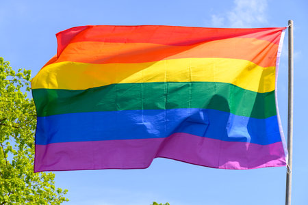 Gay pride rainbow colors flag and blue sky outdoorの写真素材