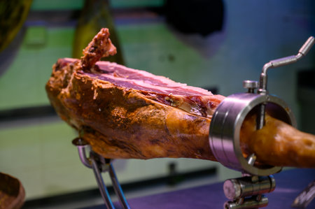 Leg of pork serrano Iberian cured jamon on stand in Spanish butcher's shop close upの写真素材