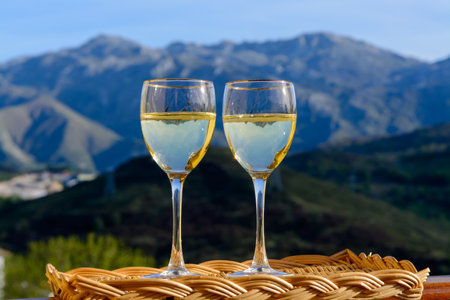 Tasting of swiss or savoy dry white wine with Alpine mountains peaks on background in sunny dayの写真素材
