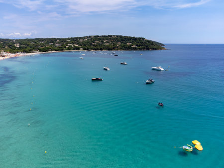Aerial view on boats, crystal clear blue water of legendary Pampelonne beach near Saint-Tropez, summer vacation on white sandy beach of French Riviera, Var, Franceの写真素材