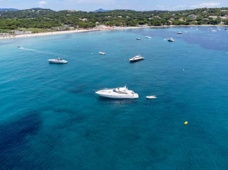Aerial view on boats, crystal clear blue water of legendary Pampelonne beach near Saint-Tropez, summer vacation on white sandy beach of French Riviera, Var, Franceの写真素材