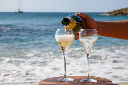Summer time in Provence, two glasses of cold champagne cremant sparkling wine on sandy beach near Saint-Tropez in sunny day, Var department, vacation in Franceの写真素材