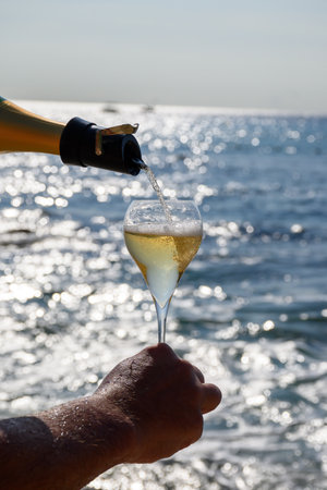 Summer time in Provence, two glasses of cold champagne cremant sparkling wine on sandy beach near Saint-Tropez in sunny day, Var department, vacation in Franceの写真素材
