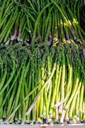 Fresh raw green organic asparagus vegetables for sale in french Provencal farmers market in Arles, Franceの写真素材