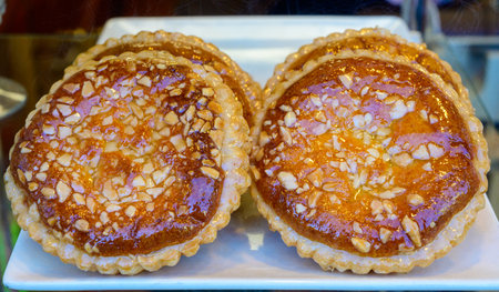 Fresh baked pastries and sweets on display in artisan Spanish confectionery shop close up
