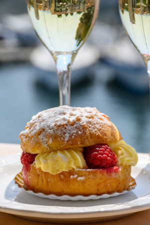 Cake Tarte tropezienne or La Tarte de Saint-Tropez - dessert pastry consisting of filled brioche with cream and fresh berries served outdoor.の写真素材