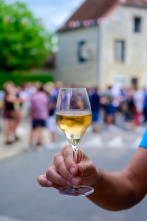 Tasting of sparkling white wine with bubbles champagne on summer weekend festival route of champagne in Celles-sur-Ource, Cote des Bar, Champagne region, Franceの写真素材