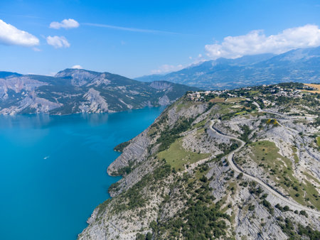 Aerial view on blue lake of Serre-Poncon, reservoir border between Hautes-Alpes and Alpes-de-Haute Provence departments, one of largest in Western Europeの写真素材