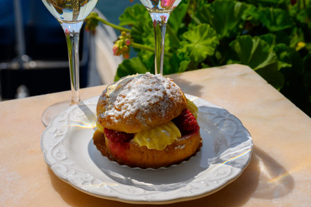 Cake Tarte tropezienne or La Tarte de Saint-Tropez - dessert pastry consisting of filled brioche with cream and fresh berries served outdoor.の写真素材