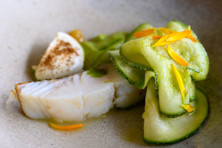 Exquisite white fish zucchini dish of modern French haute cuisine prepared with fresh organic...
