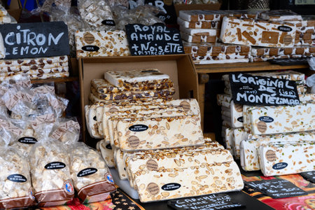 Fresh dessert traditional nougat with nuts and fruits. English translation: Original from Montelimar, caramel butter, salt from Camargue, artisanal production, lemon, king's almond.の写真素材