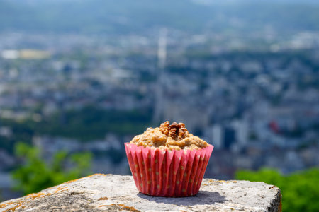 Gateau Grenoblois, French Walnut Coffee Cake, specialty from Grenoble and view on central part of Grenoble city from Bastille fortres witn mountains and old cable cars , Isere, Franceの写真素材