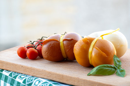 Italian semi hard handmade smoked and white scamorza cheese, from cow milk from Apulia or Calabria regions close upの写真素材