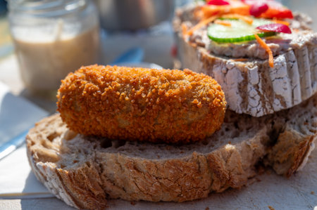 Dutch fast food, deep fried croquettes filled with ground beef meat served on bread, close upの写真素材