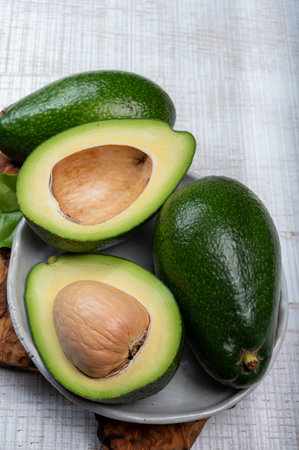 Green ripe avocado fruits from organic avocado plantation - healthy vegan and vegetarian food