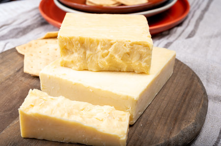 British cheeses collection, Scottish colored and English matured cheddar cheeses close up