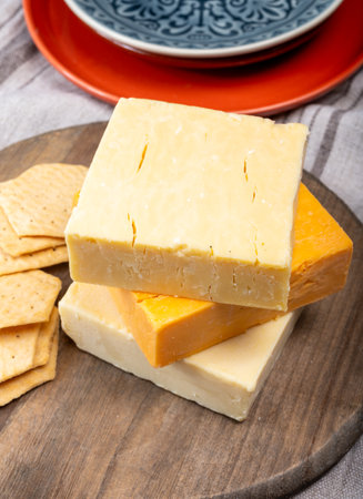 British cheeses collection, Scottish colored and English matured cheddar cheeses close up