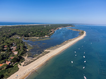 View on Arcachon Bay with many fisherman's boats and oysters farms near Le Phare du Cap Ferret and Duna du Pilat, Cap Ferret peninsula, France, southwest of Bordeaux, France's Atlantic coastline in sunny dayの写真素材